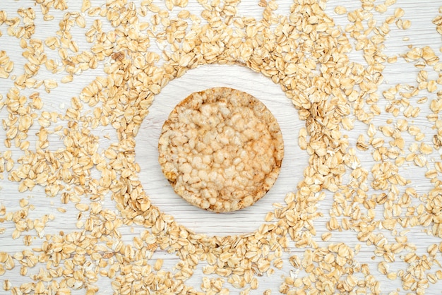 Top view raw oatmeals on white with cracker cereal cornflakes breakfast