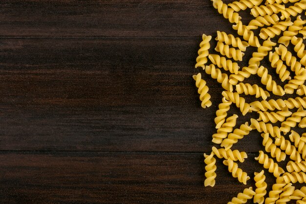 Top view of raw pasta on wooden surface