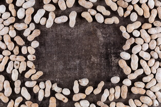 Top view raw peanuts frame with copy space on stone  horizontal