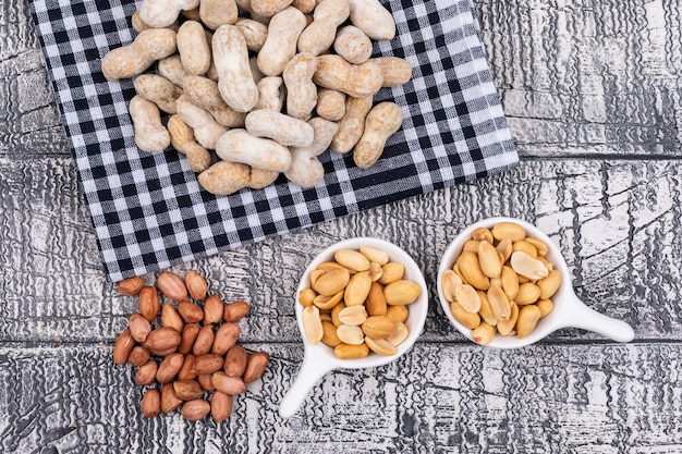 Top view raw peanuts on table cloth on wooden  horizontal