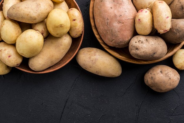 Top view raw potatoes on bowl