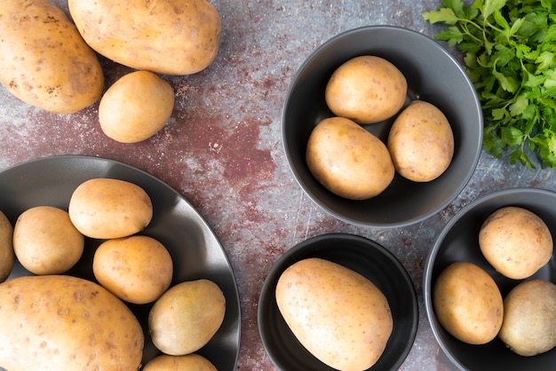 Top view raw potatoes in bowls