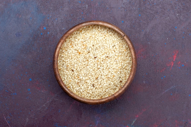 Free photo top view of raw product inside round brown pot on dark surface