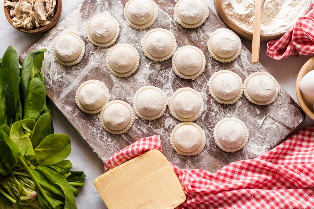 Top view of raw ravioli with ingredients