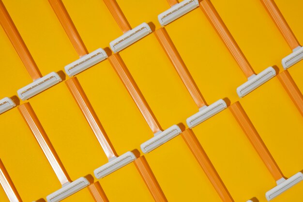 Top view razor blades with yellow background