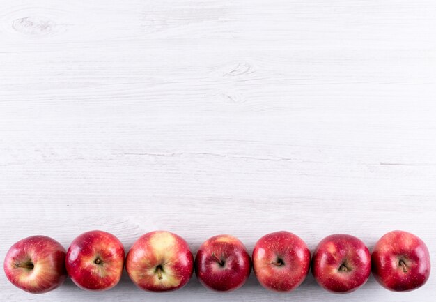 Top view red apples with copy space on white wooden  horizontal