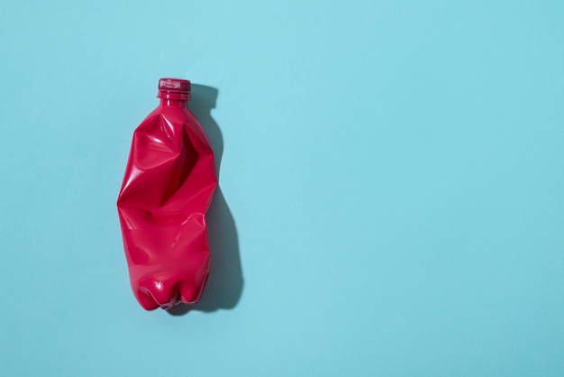 Top view red bottle on blue background