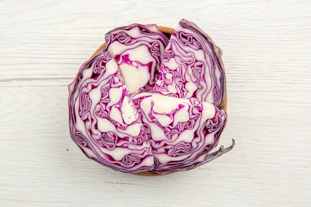 Top view red cabbage slices in bowls on grey table