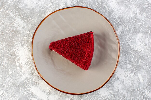 Top view red cake slice fruit cake piece inside plate on the grey background cake sweet tea