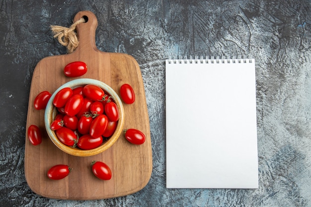 Top view red cherry tomatoes with notepad