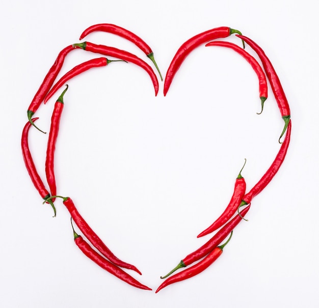 Top view red chili pepper heart on white  horizontal