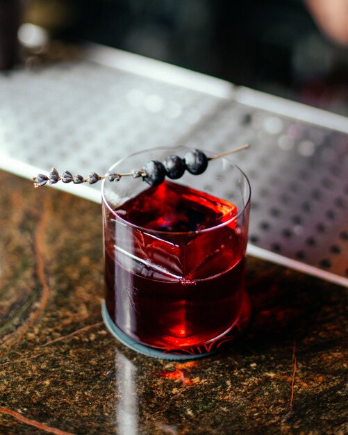 A top view red cocktail inside little glass on the bar desk cocktail drink alcohol juice water