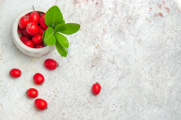 Free photo top view red fruits on the white table berry red fruit