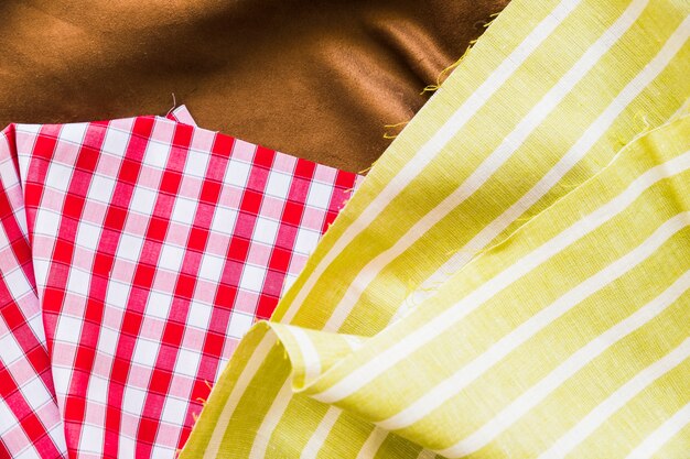 Top view of red gingham with two textile fabric