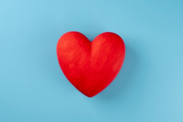 Top view red heart on blue background