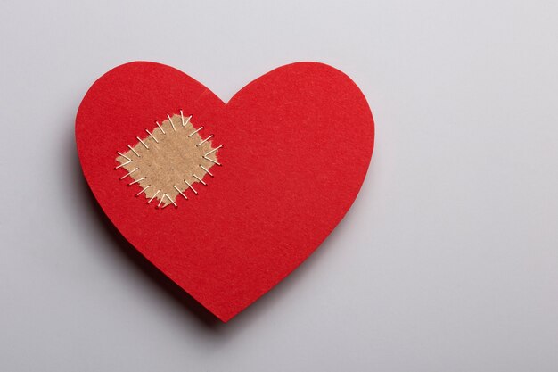 Top view red heart with patch on white background