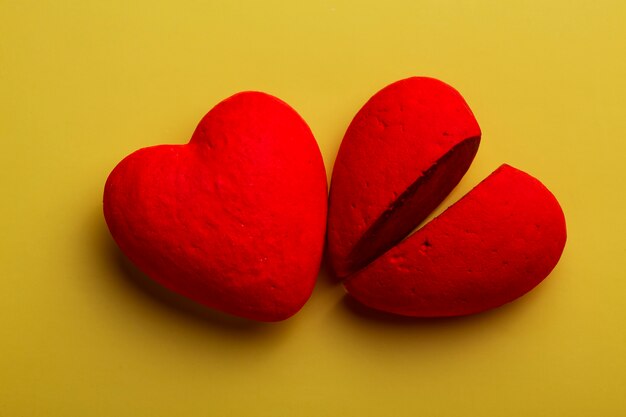 Top view red hearts on yellow background