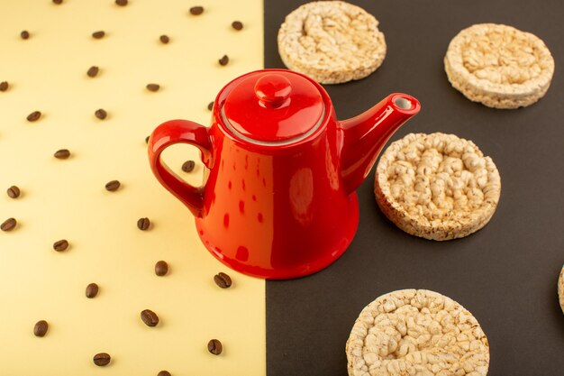 Free photo a top view red kettle with brown coffee seeds and crackers