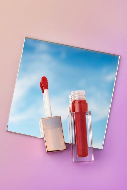 Free photo top view red lip gloss on mirror