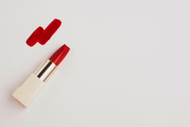 Top view red lipstick on white background