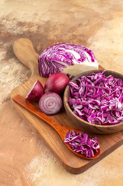 Top view red onions and cabbage on a wooden cutting board waiting for healthy salad preparation on a wooden background with space for text