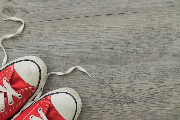 Free photo top view of red trainers on wooden surface