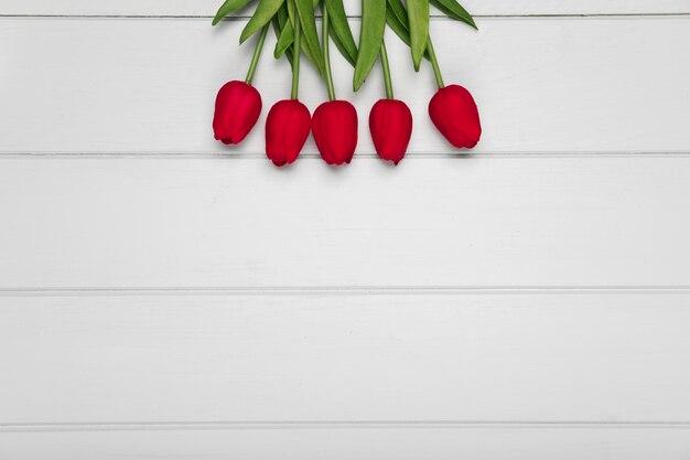 Free photo top view red tulips with copy-space