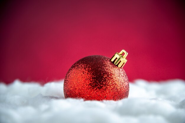 Top view red xmas tree ball on red isolated table free space