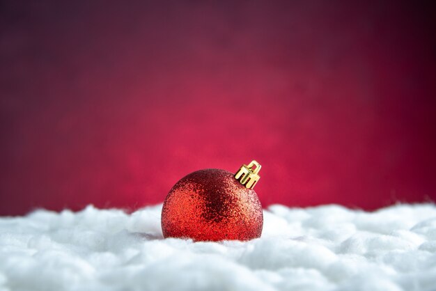 Top view red xmas tree ball on red isolated table