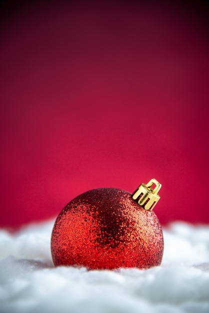 Top view red xmas tree toy on red isolated table free space