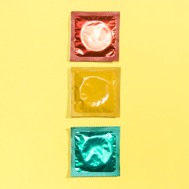 Top view red, yellow and green condoms