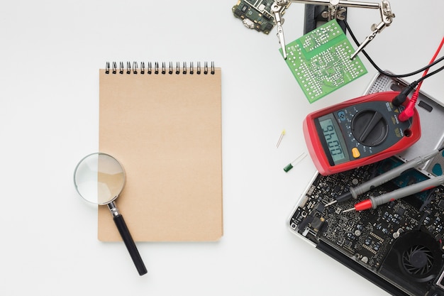 Top view reparation of a laptop with notepad