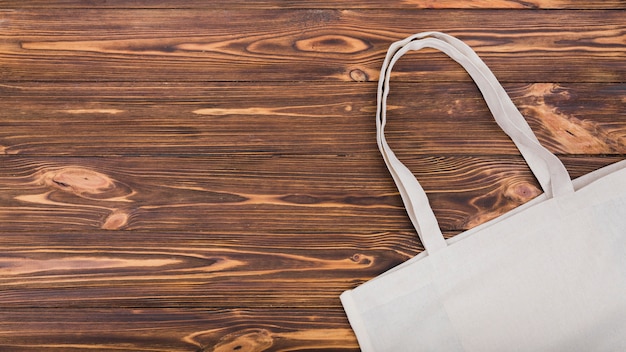 Top view of reusable bag on wooden surface with copy space