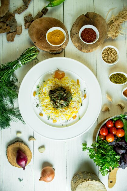 Top view of rice with stewed meat and herbs