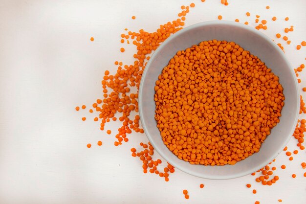 Top view of rich in vitamins lentils on a bowl with lentils isolated on a white wall with copy space