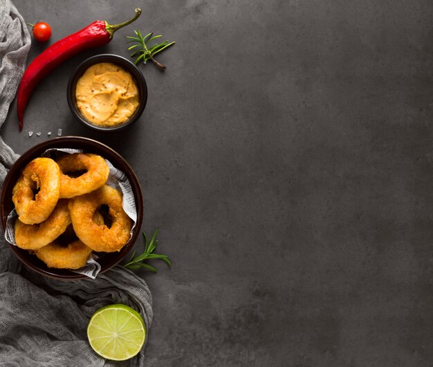 Top view of ring fries with chili pepper and copy space