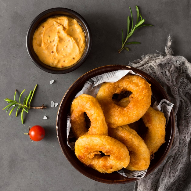 Top view of ring fries with mustard and herbs