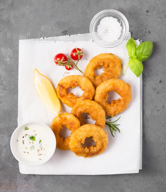 Free photo top view of ring fries with sauce and salt