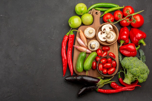 Top view ripe fresh vegetables on a grey background