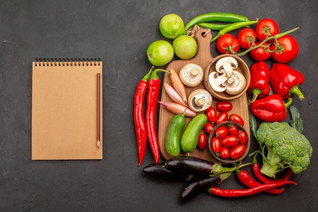 Top view ripe fresh vegetables with mushrooms on dark background