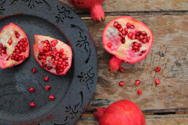 Top view of ripe pomegranate fruit on antique plate