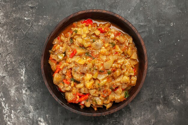 Top view of roasted eggplant salad on dark surface