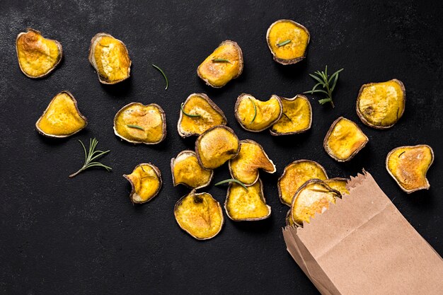 Top view of roasted potatoes with paper bag and rosemary