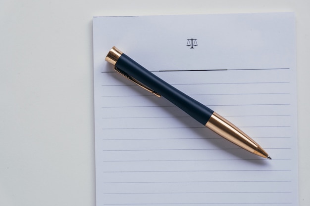 Top view of a rollerball pen placed on a piece of white striped paper