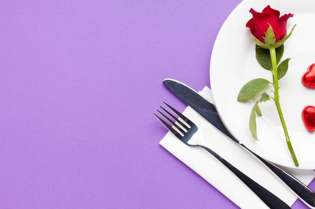 Top view romantic table setting on purple background