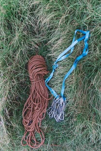 Top view of rope and carabiners in grass