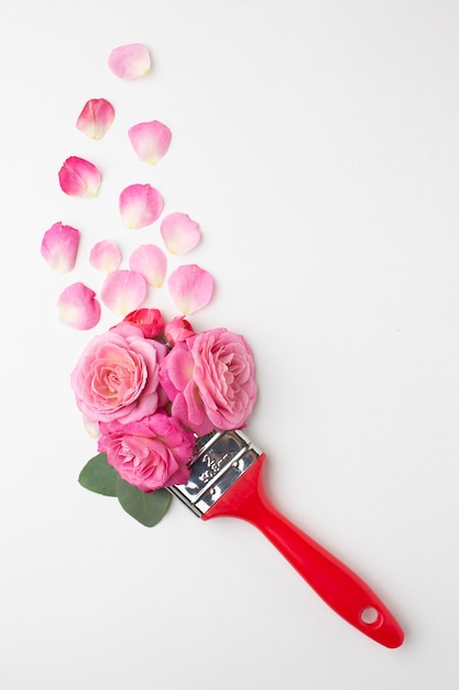 Top view roses flowers and painting brush