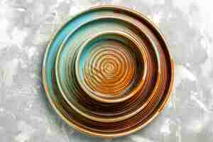Free photo top view of round brown plates different sized empty isolated on light grey surface