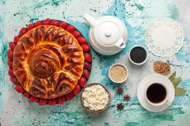 Top view round delicious pie with fresh strawberries on the light-blue surface