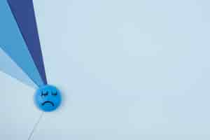 Free photo top view of sad face with paper for blue monday